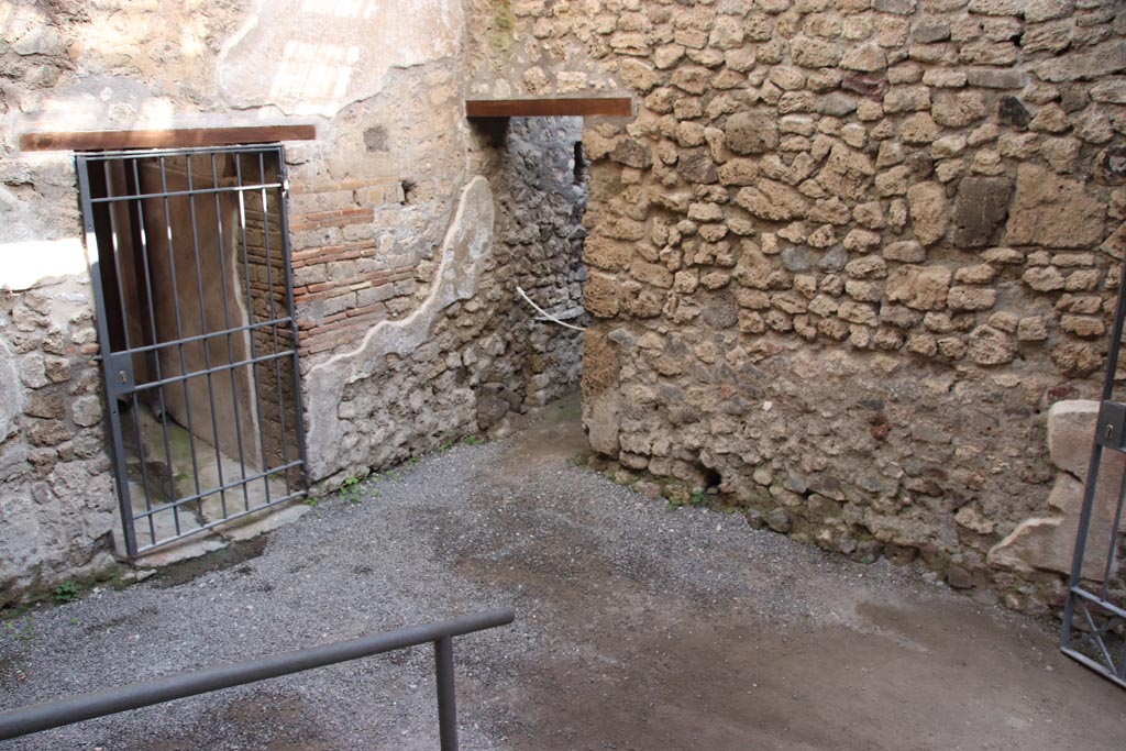 VI.15.27 Pompeii. October 2023. 
Looking north-east from steps towards corridor to atrium, on left, and doorway to stable, in centre. Photo courtesy of Klaus Heese.
