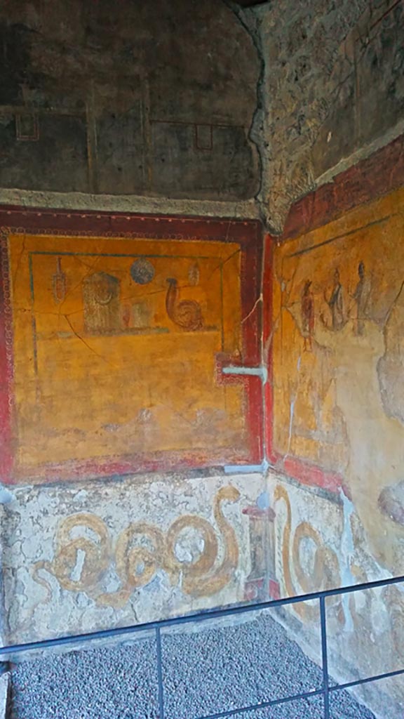 VI.16.7 Pompeii. May 2006. Room F, lararium in south-east corner of peristyle.   According to Boyce, in the south-east corner is a shrine dedicated to the cult of the Egyptian deities. On each wall a large yellow panel is marked off by a broad red border. See Boyce G. K., 1937. Corpus of the Lararia of Pompeii. Rome: MAAR 14. (p.56, no.220)
