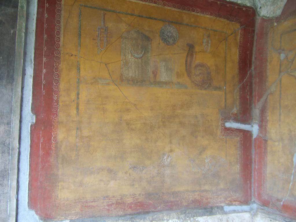 VI.16.7 Pompeii. May 2006. Room F, painting of the attributes of Isis on the Lararium in the peristyle.