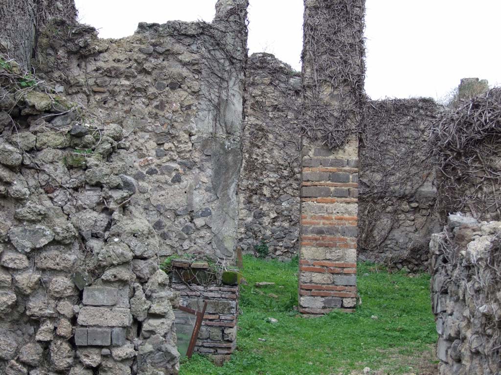 VI.16.10 Pompeii. December 2007. Looking west through atrium or corridor to rear of house.
According to NdS, on the south side of the corridor was a cubiculum C (left of photo).
The cubiculum had a floor of cocciopesto, white walls and a window in its west wall.
From the corridor through a wide doorway that formed a step one entered into the covered area E.
This was excavated on 10th May 1904.
The floor was beaten earth, and preserved on the walls were traces of rough plaster.
The east side consisted of four pillars, between the two central pillars was the entrance from the corridor.
The window from cubiculum C was between the two pillars on the south side.
The two on the north side formed a frame that formed one of the walls of a cupboard (armarium).
