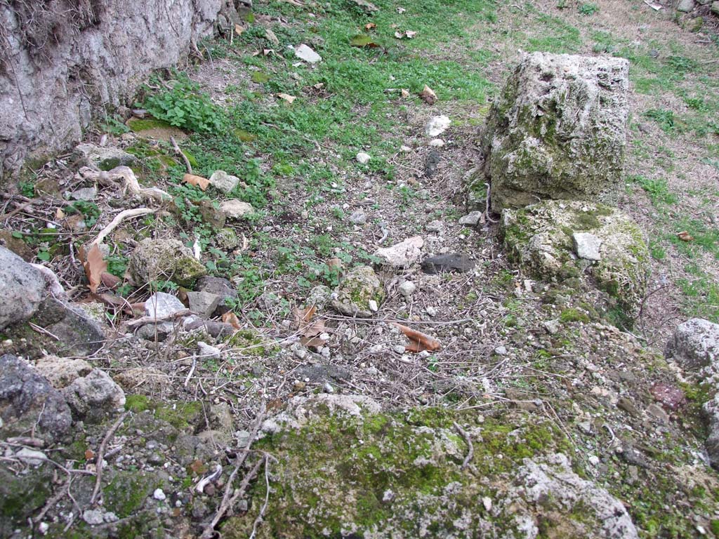 VI.16.12 Pompeii. December 2007. Remains of a two-sided masonry counter.
The top of the counter was covered with fragments of coloured marble and the sides were faced with plaster.
In the side of the counter was found the left half of a white marble rectangular relief, with representation of masks.
On the left was the mask of a Silenus crowned with ivy, also a rock and a plate. To the right was a burning cylindrical altar. 
See Eschebach, L., 1993. Gebäudeverzeichnis und Stadtplan der antiken Stadt Pompeji. Köln: Böhlau. (p.227)
See Notizie degli Scavi di Antichità, 1908, (p.61)
