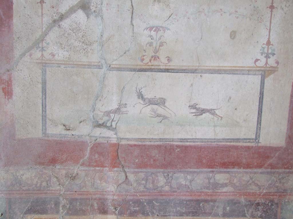 VI.16.15 Pompeii. December 2006. South wall of small tablinum D, showing detail of wall painting of stag hunt with dogs. 