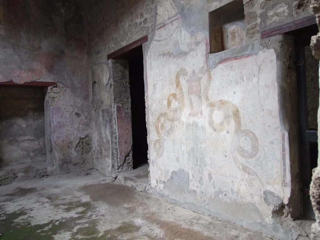 VI.16.15 Pompeii. December 2006. North-west corner of atrium B, with doorway to room E, on left.
Doorways to rooms I and K are separated by the painted lararium on the north wall. 
