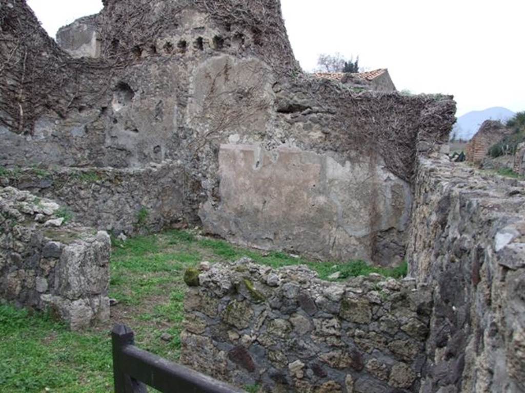VI.16.18 Pompeii. December 2007. Doorway to room to north of entrance. According to NdS, the doorway in the north wall opened into a square room. It had a threshold of lava, concrete floor, and the walls were roughly plastered.