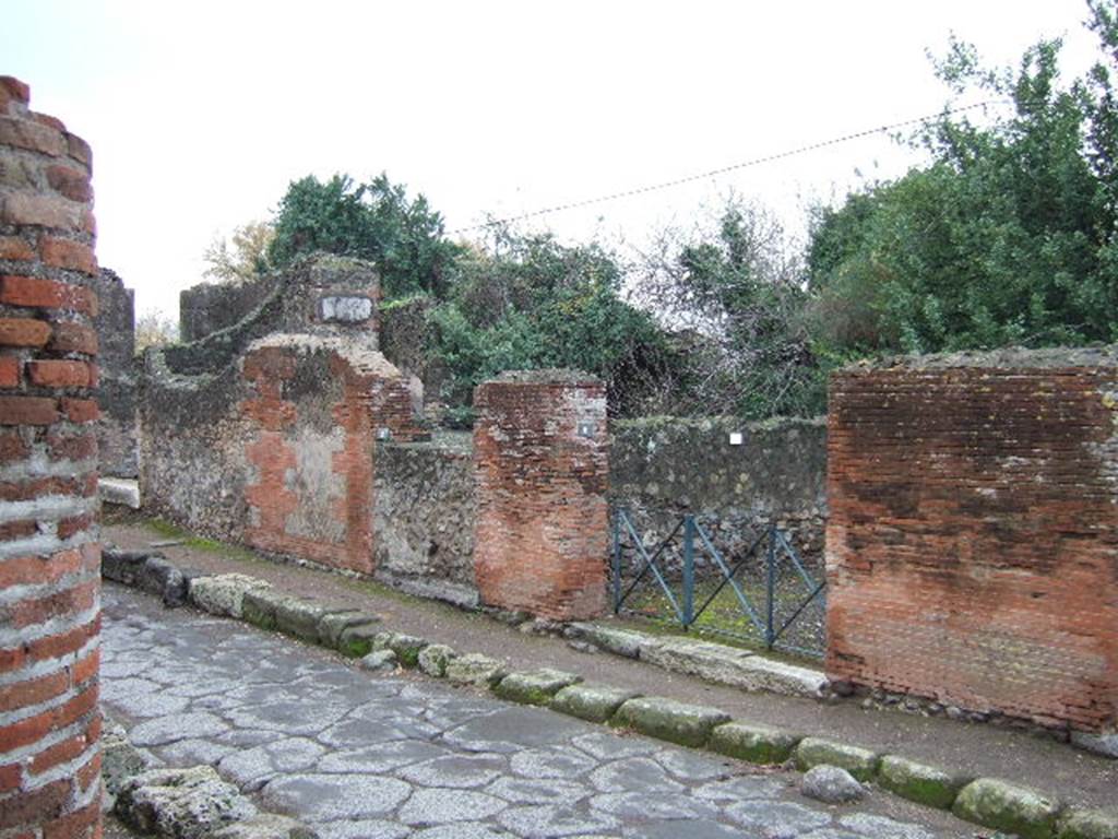 VI.17.9 Pompeii, blocked and VI.17.8, Pompeii. December 2005. Entrance doorway with iron gate.  According to Eschebach, this shop was bombed in 1943.  It may have been damaged when a bomb fell on VI.17.9 and destroyed the three dividing walls on the north side of the atrium.  See VI.17.9.
According to Fiorelli, in the vicinity of the two shops at VI.17.8 and 7, were found various electoral recommendations.  Many of these were cut from the walls and taken to Naples Museum, the most noted candidate being –
CVSPIVM  PANSAM
AED FABIVS EVPOR PRINCEPS LIBERTINORVM    [CIL IV 117]
See Pappalardo, U., 2001. La Descrizione di Pompei per Giuseppe Fiorelli (1875). Napoli: Massa Editore. (P.159).  According to Varone and Stefani, CIL IV 117, was probably found between entrances 9-13. 
It was cut from the wall and taken to the Naples Museum, Inventory number 4722.  See Varone, A. and Stefani, G., 2009. Titulorum Pictorum Pompeianorum, Rome: L’erma di Bretschneider, (p.342)
According to Varone and Stefani, found written on the walls between VI.17.8 and 7, along the Via Consolare were –  CIL IV 118, 119, 120, 121, 122, 123, and 124.  See Varone, A. and Stefani, G., 2009. Titulorum Pictorum Pompeianorum, Rome: L’erma di Bretschneider, (p.338-341).
According to Pagano and Prisciandaro, found in September 1764, “on a wall of one of the dwellings”, were –
Trebium et Gavium
aed(iles) o(ro) v(os) f(aciatis)       [CIL IV 118, Naples Inventory number ?)
Licinium Faustinum
aed(ilem) v(irum) b(onum) o(ro) v(os) f(aciatis)      [CIL IV 119]
M(arcum) Cerrinium Vatiam
aed(ilem) o(ro) v(os) f(aciatis)
scr(ipsit) Infantio
Fabius Eupor rog(at)      [CIL IV 120, Naples inventory number ?)
C(aium) Iulium IIvir(um) i(ure) d(icundo)
Polybium dig(num) r(ei) p(ublicae)       [CIL IV 121, Naples Inventory number 4677] 
Suettium cum Epidio
IIvir(os) i(ure) d(icundo) o(ro) v(os) f(aciatis) dig(ni) sunt
Herennium et Verum
aed(iles) o(ro) v(os) f(aciatis)      [CIL IV 122, Naples Inventory number 4677]
Trebium aed(ilem)
v(irum) b(onum) o(ro) v(os) f(aciatis)      [CIL IV 123, Naples Inventory number 4673]
M(arcum) Cerrinium Vatiam aed(ilem)
o(ro) v(os) f(aciatis) d(ignum) r(ei) p(ublicae) Iarinus [3]      [CIL IV 124, Naples Inventory number 4673]
See Pagano, M. and Prisciandaro, R., 2006. Studio sulle provenienze degli oggetti rinvenuti negli scavi borbonici del regno di Napoli.  Naples : Nicola Longobardi. (p.48)  PAH I, 1, 162

