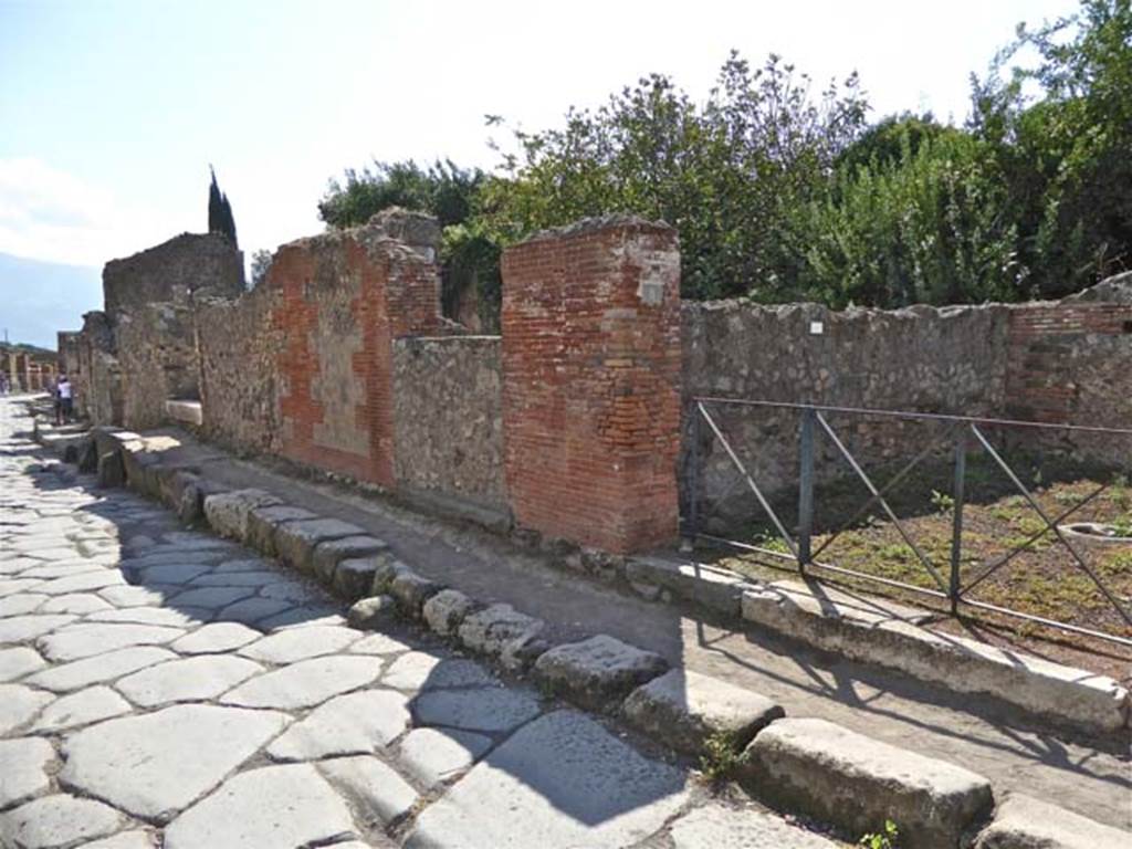 VI.17.10 Pompeii. May 2011. Looking south-west on Via Consolare towards raised pavement outside of entrance steps and doorway. Photo courtesy of Michael Binns.