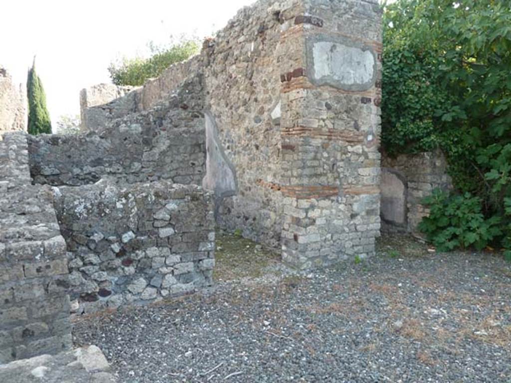 VI.17.10 Pompeii. December 2007. South side of atrium from entrance. Looking towards doorways of two of the three cubicula.
According to Allroggen-Bedel – In the room next to the Ala, right from room No.10 (doorway on right of photo), there is no depression for the bed.  In the room on the left (from room No.10), next to the steps, you can still see the remains of a red zoccolo, and a yellow middle zone.  The remains of these decorations agree with La Vega description of room No.13 –
“From the 9th to the 18th December, we excavated the indicated small room. The floor was of slabs of crushed brick (lastrico di mattoni pesto).  In the plaster the zoccolo has the red background: the bottom of the panels that lay above the zoccolo was yellow with some birds in the middle; the bands that divided these squares were red, embellished with grotesque architecture, which still adorned the decoration above that had a white background.”

