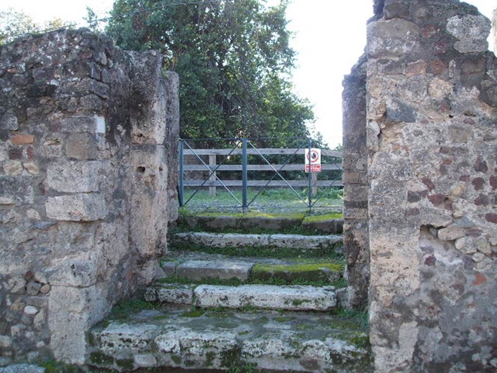 VI.17.13 Pompeii. December 2004. Entrance doorway with three steps, with door pillars leading to vestibule with two steps.