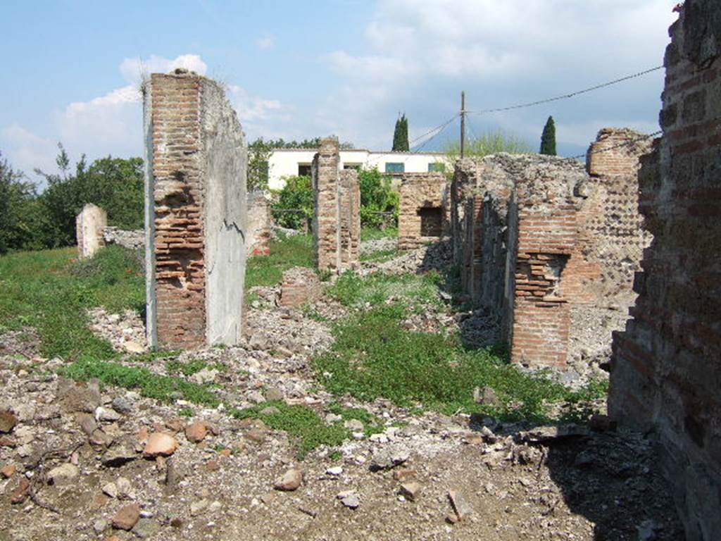 VI.17.32 Pompeii. May 2006. Looking north along remains of east side of rear peristyle area, taken from VI.17.41.
According to Jashemski, steps at each entrance (VI.17.32 and 36) led to an atrium: immediately at the rear of these there was a large peristyle garden.
This was enclosed by a portico on 4 sides.
In the middle of the garden was a pool with a fountain, with little steps leading into the pool, but this was no longer in existence when Breton wrote.
See Jashemski, W. F., 1993. The Gardens of Pompeii, Volume II: Appendices. New York: Caratzas. (p.166 with plan)
See Breton, Ernest. 1870. Pompeia, Guide de visite a Pompei, 3rd ed. Paris, Guerin. (p.266)
According to Pagano –
VI.17.32 and 36. Casa di Giulio Polibio.
“Vi si ascende per due ingressi communicanti con due sale o vestibuli, che tengono le veci dell’atrio. Tutti e due i vestiboli mettono in un gran peristilio circondato da un portico d’ordine corinzio, e avente nel mezzo una fontana; sembra che le arcate del portico potessero chiudersi con trlai di vetro.”
(translation:
"Here, one ascends to two entrances communicating with two rooms or vestibules, which take the place of the atrium. Both vestibules lead into a great peristyle surrounded by a Corinthian portico, and having a fountain in the middle; it seems that the arches of the portico could have been closed with glass frames."
See Pagano, N. (1868).Guida di Pompei. 2nd ed. (p.58-59)
)