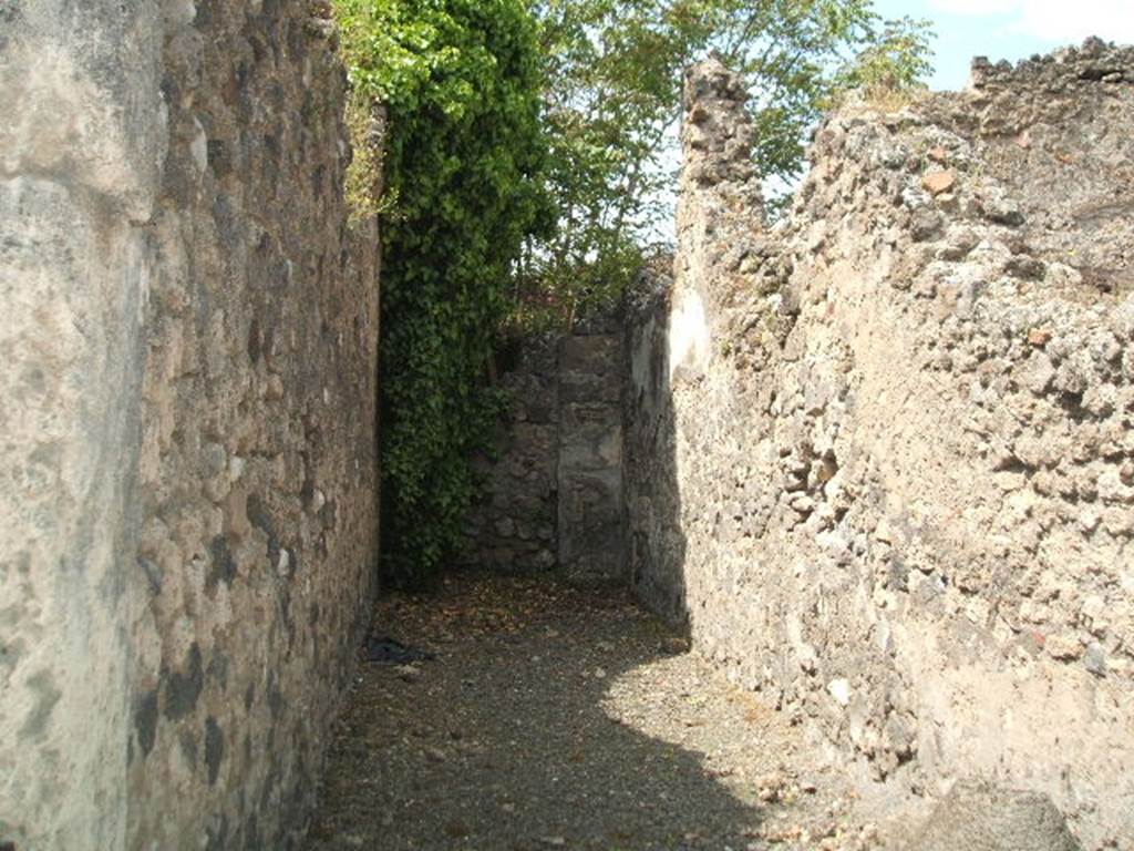 VII.1.18 Pompeii. May 2005. Looking west across long narrow room.
According to Fiorelli, it was a corridor belonging to the Stabian Baths complex, with a bricked-up doorway at the rear.
According to the Eschebach map of Pompeii, it may have been a rear entrance from VII.1.47.
See Pappalardo, U., 2001. La Descrizione di Pompei per Giuseppe Fiorelli (1875). Napoli: Massa Editore. (p.75)