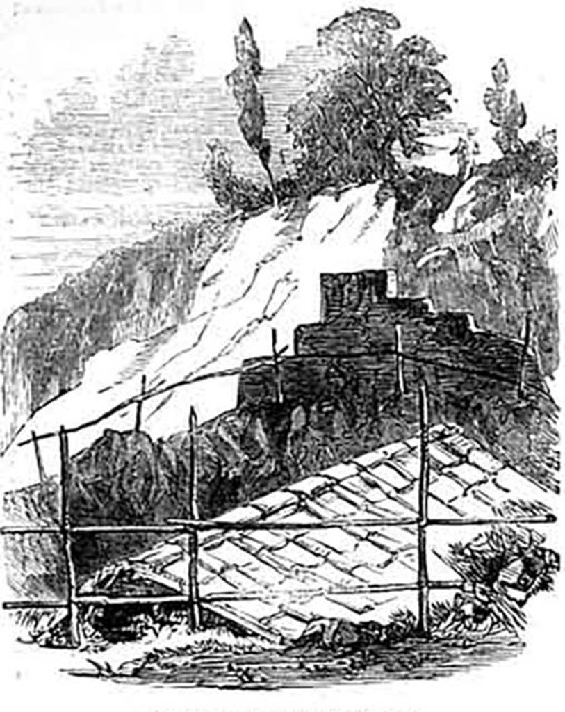 VI.1.25 Pompeii. 1853. Drawing titled Roof Excavation Near the Gate of Stabia.
From The Illustrated London News, 30th April 1853, p. 329.
On the 14th April from Naples our own correspondent reported that “Threading our way through the back doorway of this house, we came upon the most remarkable discovery which has yet taken place, viz., the complete roofing of a house, of which I send you a drawing. It will be remembered that Pompeii having been destroyed by falling ashes, and then covered by earth, was the occasion of the roofs falling in. The very little care used in clearing away the incumbent earth has left us in the dark about the construction of ancient roofings. Here, then, for the first time, we have a complete roof of a house formed of square tiles, about twelve inches by twelve, with coping tiles running between them; and over the back-bone, so to speak, of the construction, a cement was used to make the roofing water-tight. So perfect is the roof, that it might have been constructed yesterday, and it would suit an English cottage.”
Photo courtesy of Drew Baker.