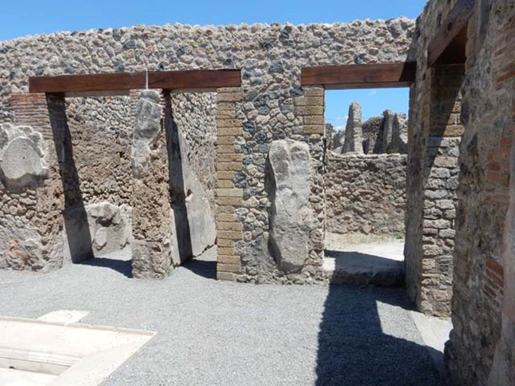 VII.1.25 Pompeii. May 2017. Looking east across atrium 24. The corridor 23 to the entrance at VII.1.25 is on the left, followed by a doorway to a small room 25, centre, and doorway to room 26 in south-east corner of atrium. The doorway to room 29 is to the right. Photo courtesy of Buzz Ferebee.
According to Fiorelli -
On the left, we find a cupboard, a storeroom with a painting of serpents, under which was the shelf to deposit the offerings, and the stairs to go up above: there we could read several graffiti, not least the acclamation NVMMIANO FELICITER written in red, and written in carbon -
SIICVNDVS
RIIGIMONI
VIIII TIINIIT
FIILICITIIR
which now we can no longer see/read. There follows another cubiculum, and an ala.
(A sinistra trovansi un’apotheca, una cella penaria con la dipintura dei serpi, sotto cui lo sporto per depositarvi le offerte, e la scaletta per montare di sopra: vi si leggevano varie eipigrafi graffite, nonche l’acclamazione NVMMIANO FELICITER scitta in rosso, e col carbone –
SIICVNDVS
RIIGIMONI
VIIII TIINIIT
FIILICITIIR
che ora piu non si vede. Seguono un altro cubicolo, ed un’ ala.)
See Pappalardo, U., 2001. La Descrizione di Pompei per Giuseppe Fiorelli (1875). Napoli: Massa Editore. (p.76)