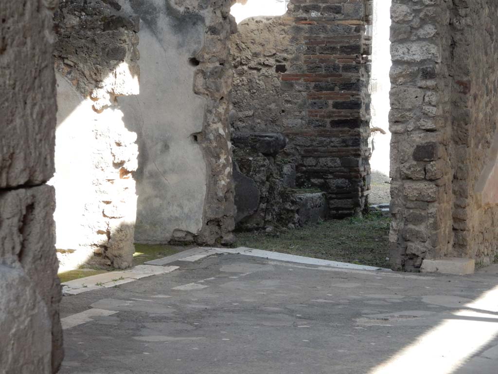 VII.1.40 Pompeii. June 2019. Looking towards south-east corner of atrium. Photo courtesy of Buzz Ferebee.
Left of centre is the doorway into the kitchen area, according to Boyce –
“In the kitchen was found a fragmentary painting with the figures of the Lares along remaining.”
See Boyce G. K., 1937. Corpus of the Lararia of Pompeii. Rome: MAAR 14, (p.61, no.245).