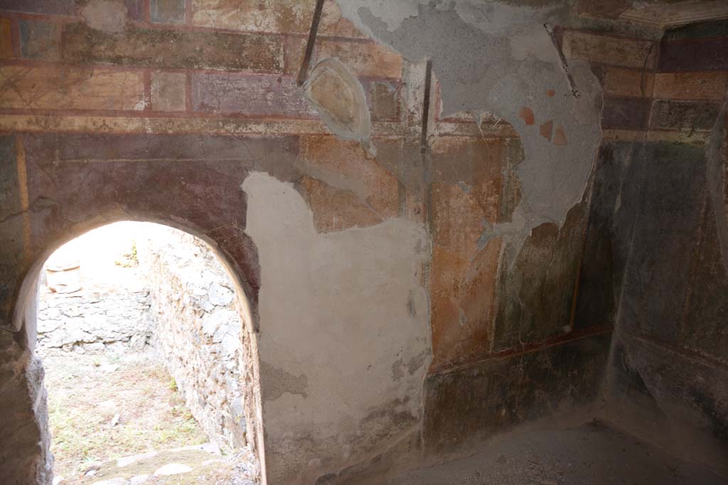 VII.1.40 Pompeii. September 2019. Caldarium 16, north wall, with arched doorway leading into Kitchen 14, on left.
Foto Annette Haug, ERC Grant 681269 DÉCOR.
According to PPM –
“In the south wall of the kitchen (i.e. north wall of caldarium) there is an arched doorway to the caldarium beneath which was the entrance to the underlying hypocaust.”
See Carratelli, G. P., 1990-2003. Pompei: Pitture e Mosaici. VI. (6). Roma: Istituto della enciclopedia italiana, p.429, no. 97.