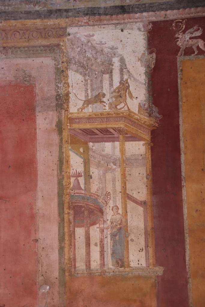 VII.1.47 Pompeii. September 2021.  
Exedra 10, detail figure of muse (Clio or Calliope?) in painted architectural decoration on east side of central painting on north wall.
Photo courtesy of Klaus Heese.    
