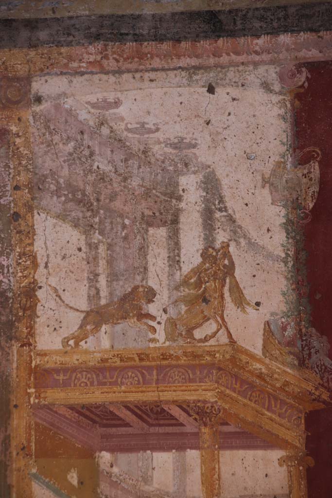 VII.1.47 Pompeii. September 2021.  
Exedra 10, detail of painted centaur with lion, from east end of north wall. Photo courtesy of Klaus Heese.  

