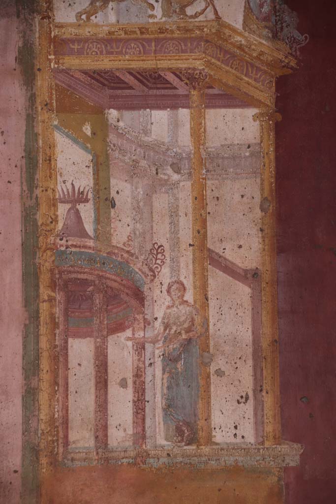 VII.1.47 Pompeii. September 2021.  
Exedra 10, detail of muse (Clio or Calliope?) in painted architectural decoration on east side of central painting on north wall.
Photo courtesy of Klaus Heese.    
