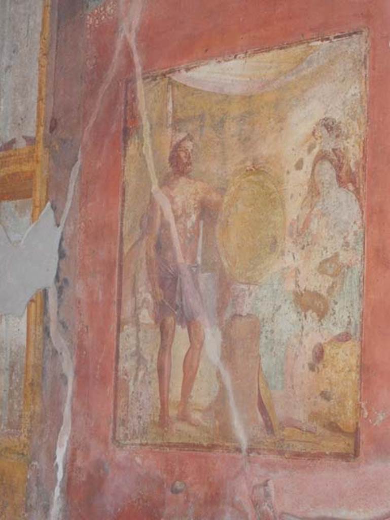 VII.1.47 Pompeii. May 2017. Exedra 10, east wall.
Wall painting of Thetis at the forge of Hephaestus receiving the shield for Achilles. 
Behind Thetis is another figure (Fate or Destiny?). 
Photo courtesy of Buzz Ferebee. 
See Carratelli, G. P., 1990-2003. Pompei: Pitture e Mosaici: Vol. VI.  Roma: Istituto della enciclopedia italiana, p. 279. 
