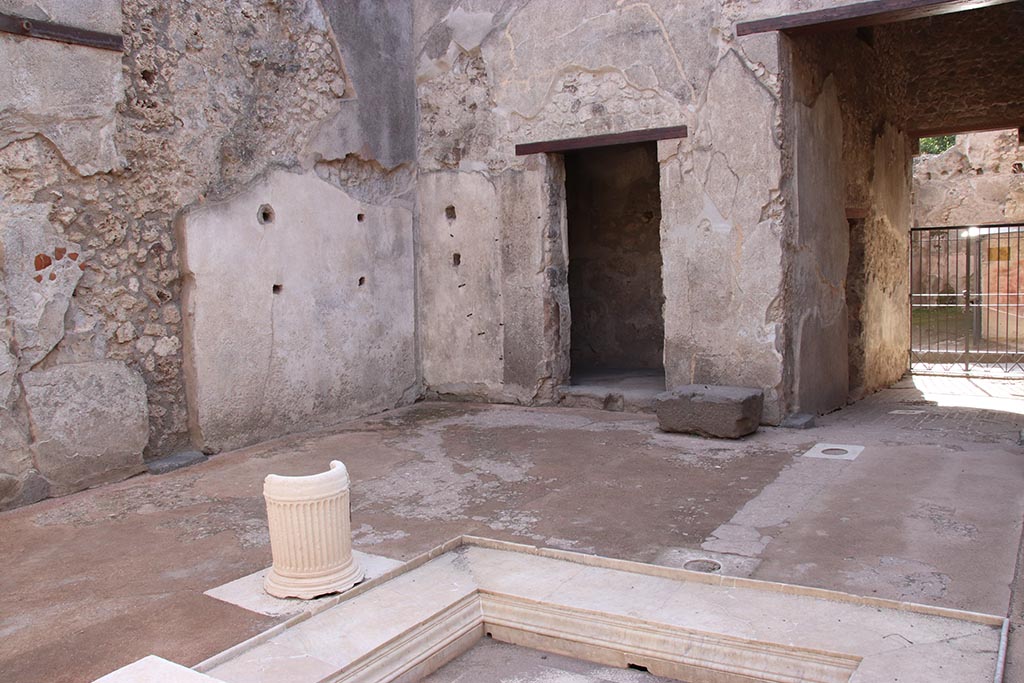 VII.1.47 Pompeii. October 2024. 
South-west corner of atrium 3, with doorway to room 4, base of money chest, and entrance corridor, on right.
Photo courtesy of Klaus Heese.
