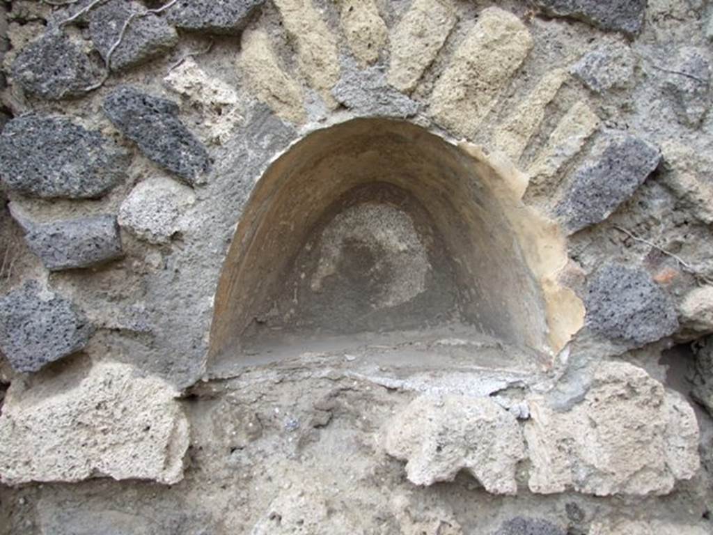 VII.2.12 Pompeii. December 2007. Niche in west wall. According to Boyce, this arched niche had walls coated with white stucco and decorated with broad red bands. Fiorelli called it la nicchia de Penati.
See Boyce G. K., 1937. Corpus of the Lararia of Pompeii. Rome: MAAR 14. (p.61, 248) 
See Pappalardo, U., 2001. La Descrizione di Pompei per Giuseppe Fiorelli (1875). Napoli: Massa Editore. (p.81)
