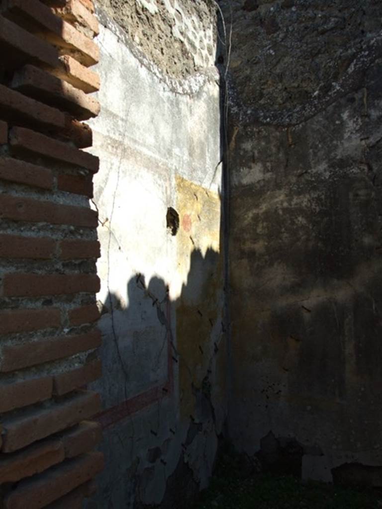 VII.2.18 Pompeii. March 2009. Room 4, north wall of cubiculum.  According to Sogliano, found on this wall was a painting of a sacred landscape with herm. It showed a herm of Priapus, a column with an urn on top and suspended from it was a bronze shield. There were also several goats near a stream shaded by trees and three bronze statues on a wide base.
See Sogliano, A., 1879. Le pitture murali campane scoverte negli anni 1867-79. Napoli: (p. 48, no: 228)
