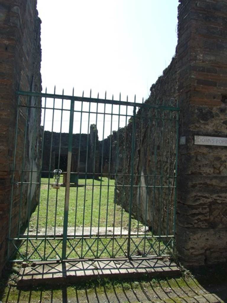 VII.2.20 Pompeii. March 2009. 
Entrance on south side of Vico del Panetierre, with short vestibule and then threshold for fauces.
According to Pagano –
“Vicoletto tra la via Stabiana e il vico Storto.
Sui due lati di questo breve vicoletto veggonsi parecchie abitazioni, che tornarono a luce verso gli ultimi mesi del 1857, ma tutte sono di poca importanza, meno l’ultima a sinistra scavata nel 1864, notevole per la sua grandezza, e per altre considerazioni ancora.
Infatti vi si scorgono tre tondi che ritraggono Paride con l’Amorino sulla destra spalla, una scrittrice col dittico nella destra e lo stilo avvicinato alla bocca, infine i busti di Marte e Venere. Vi si rinvennero gli scheletri di due cavalli, e una gran provvista di marmi colorati, dai quali ha preso l’abitazione il nome di Casa dei marmi colorati.
Ma le due piu importani scoverte che vi si fecero, sono il pozzo alto 110 palmi e trovato con una considerevole quantita di acqua, e la statuetta in bronzo del Sileno ubbriaco, che era tra le piu belle sculture del Museo Nazionale. Questa casa ha una seconda porta sul Vico degli Augustali.”
See Pagano, N. (1868). Guida di Pompei, 2nd ed. (p.42)
(translation -
On both sides of this short vicolo we see several dwellings, which came to light towards the last months of 1857, but all are of little importance, except the last to the left excavated in 1864, remarkable for its greatness, and also for other considerations. In fact, found here were three medallions which portray Paris with a Cupid on his right shoulder, a female writer with the diptych in her hand, and stylus approaching the mouth, and finally the busts of Mars and Venus. 
Also found here were the skeletons of two horses, and a large supply of colored marble, from which the house took the name of House of Coloured Marbles.
But the two most important discoveries that were found here, was the well 110 palms deep and found with a considerable amount of water, and the bronze statuette of the Drunken Silenus which is amongst the most beautiful sculptures of the National Museum. This house has a second doorway onto the Via degli Augustali.)

