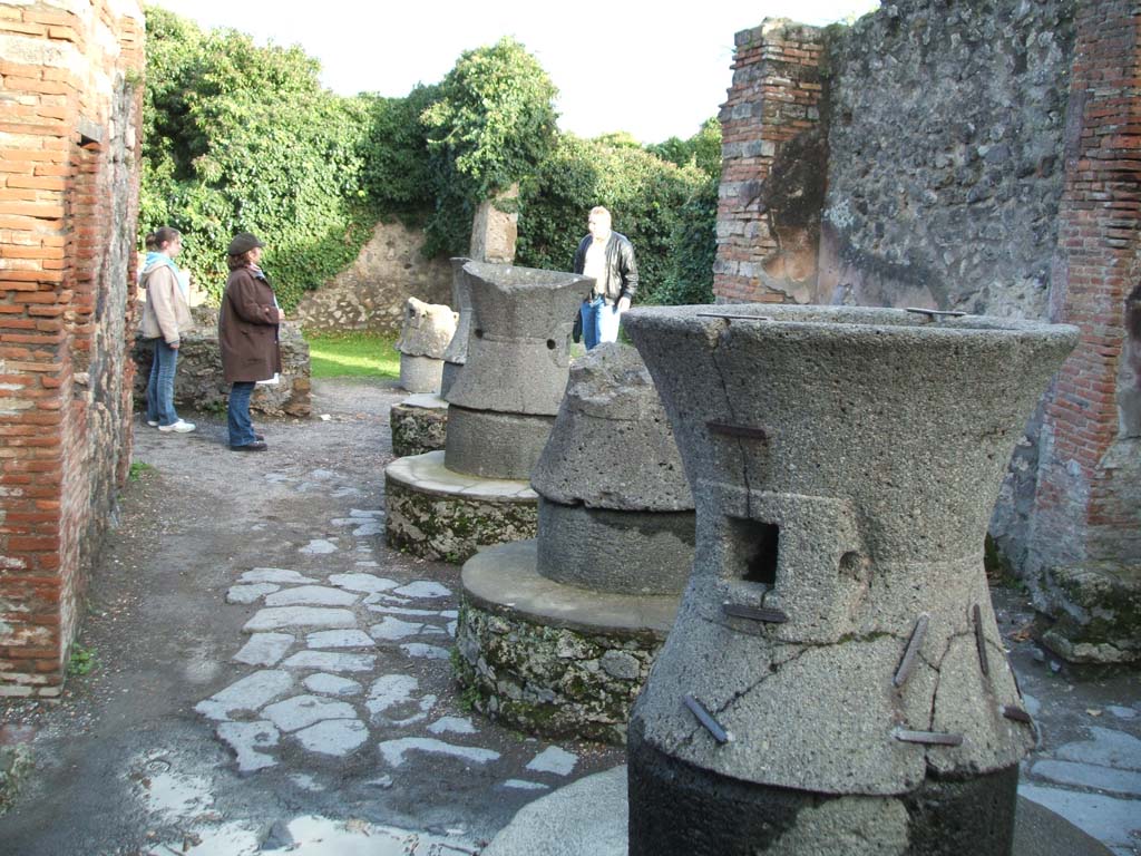 VII.2.22 Pompeii. December 2004. Looking east along four mills in bakery.