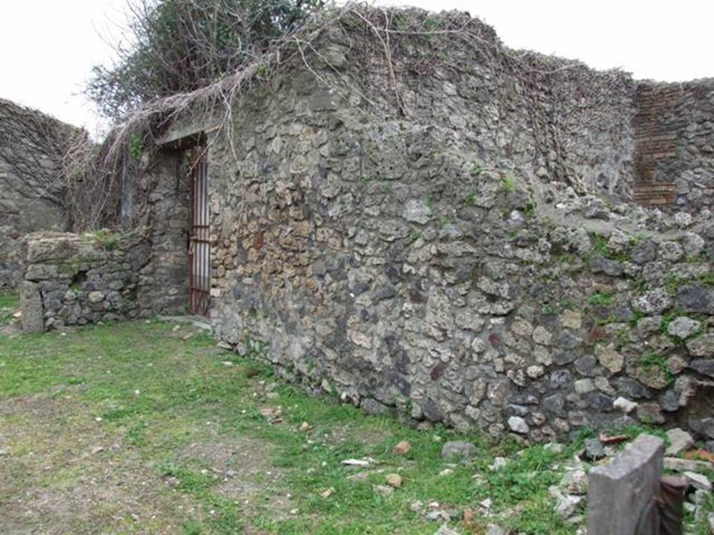 VII.3.11 Pompeii. March 2009. Doorway to garden and peristyle.
According to Boyce, against the back wall of the garden stood an aedicula lararium. He also said that from the objects found in the dwelling, Fiorelli concluded that it was owned by an Egyptian.
See Boyce G. K., 1937. Corpus of the Lararia of Pompeii. Rome: MAAR 14. (p.64, no: 264B)
See Pappalardo, U., 2001. La Descrizione di Pompei per Giuseppe Fiorelli (1875). Napoli: Massa Editore. (p. 86)
According to Giacobello, the aedicula in the garden is no longer conserved. See Giacobello, F., 2008. Larari Pompeiani: Iconografia e culto dei Lari in ambito domestico. Milano: LED Edizioni. (p. 280)
According to Jashemski, against the rear wall was an aedicula shrine.
The shrine contained statuettes of Lar, Minerva and Harpocrates, as well as a small terracotta altar. A lamp hung above. On the ground in front of the aedicula was a masonry altar. The walls on each side of the shrine were painted with trees seen growing behind a wooden fence.
See Jashemski, W. F., 1993. The Gardens of Pompeii, Volume II: Appendices. New York: Caratzas. (p. 177)
