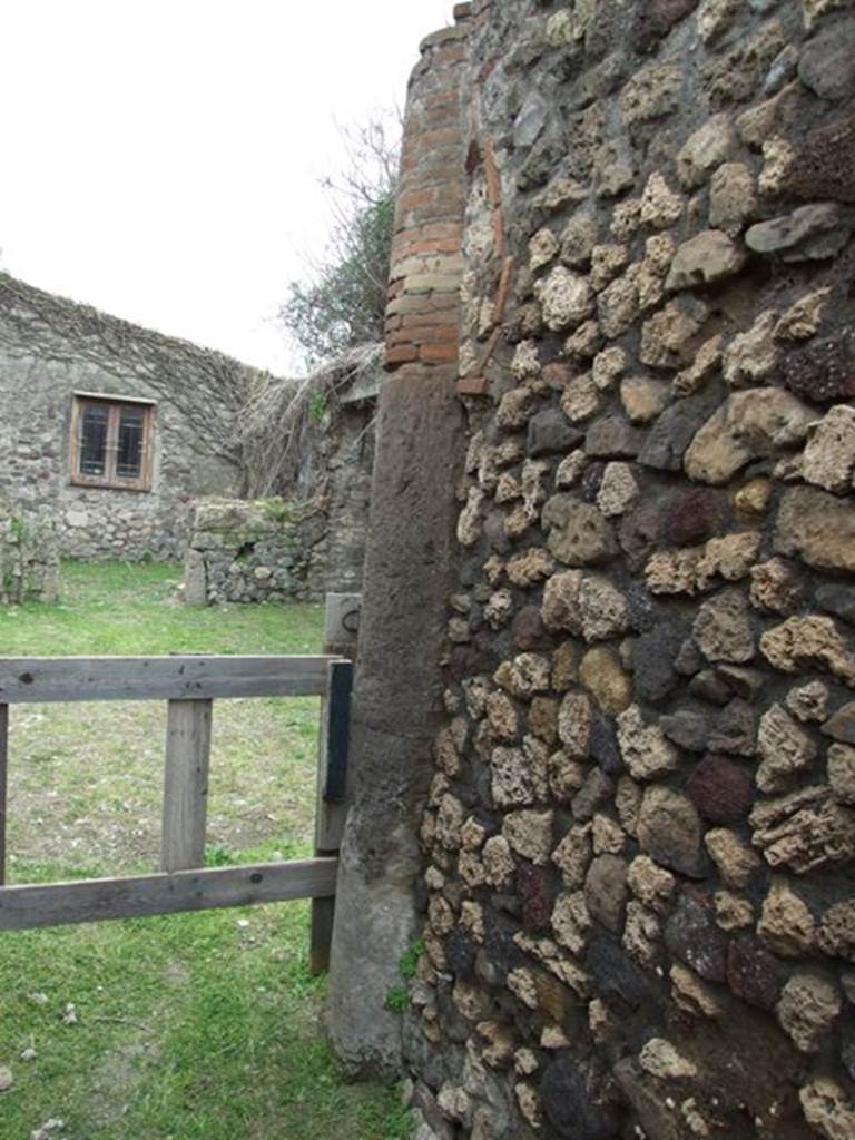 VII.3.11 Pompeii. March 2009. Brick and Tufa column on south west side of corridor.