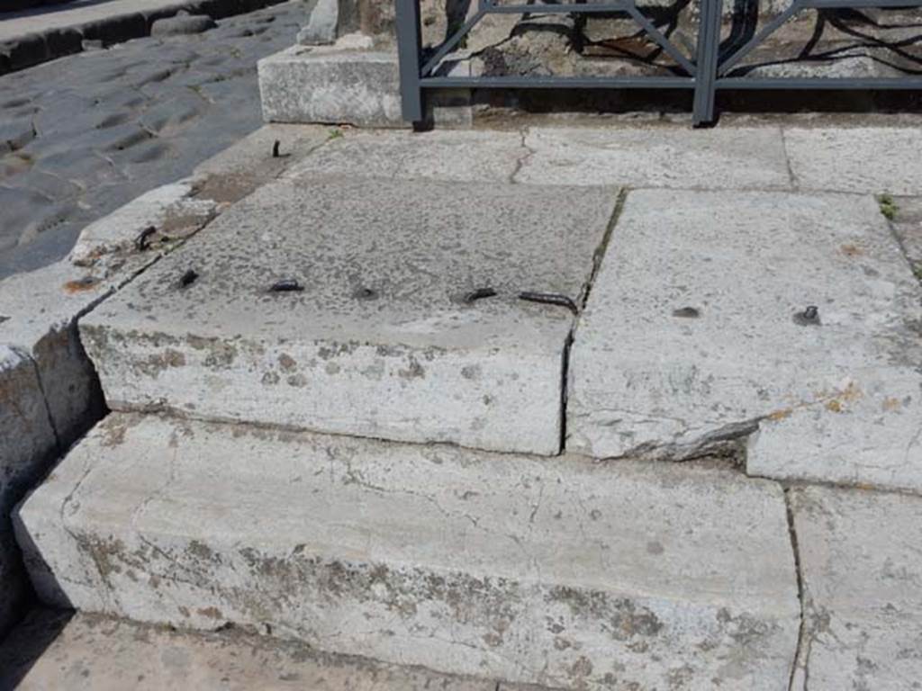 VII.4.1 Pompeii. May 2018. Steps and podium at north end. Photo courtesy of Buzz Ferebee.
According to Niccolini, All the space of the plinth that protrudes forward from the closed base had an iron latticework, the remains of which can still be seen surround this space, and one entered through two gates.
See Niccolini F, 1854. Le case ed i monumenti di Pompei: Volume Primo. Napoli, Tempio della Fortuna, Tav. I, p. 2.