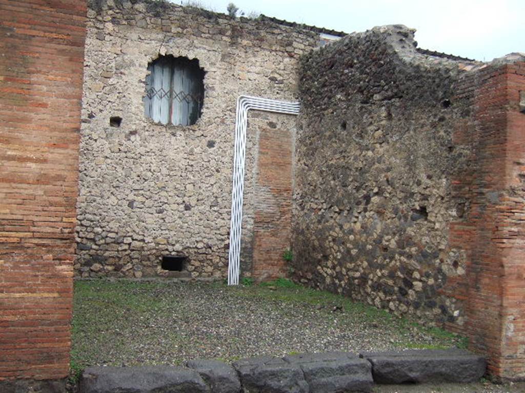 VII.4.20 Pompeii. December 2005. North and East wall of shop room.