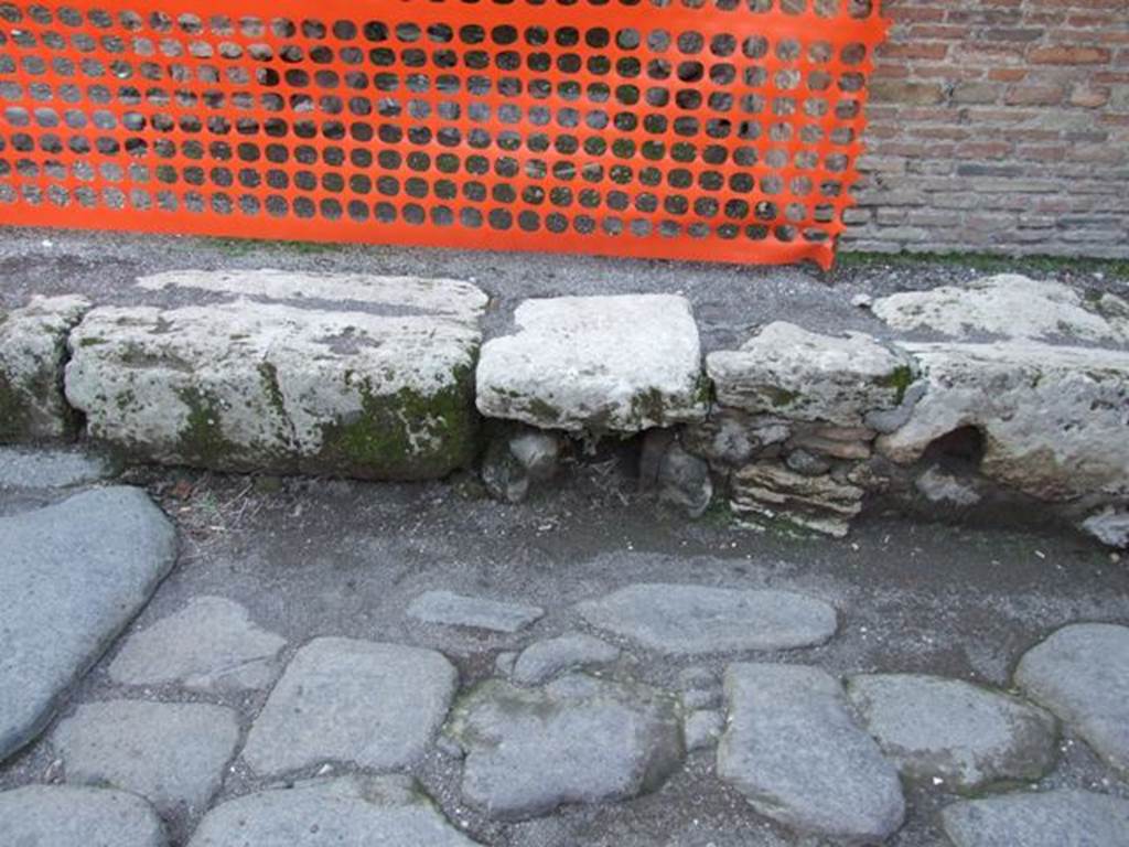 Drainage holes in kerb outside south west corner of room 21 of VII.4.48 near entrance VII.4.43. March 2009.