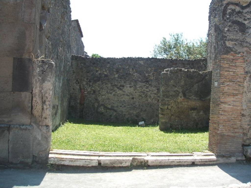 VII.4.50 Pompeii. May 2005. Looking south from entrance, across shop.
According to Fiorelli, this shop had a staircase, a latrine and a rear room.
See Pappalardo, U., 2001. La Descrizione di Pompei per Giuseppe Fiorelli (1875). Napoli: Massa Editore. (p.92).  According to Eschebach, the stairs to the upper floor were on the right, the rear room was in the south-west corner, on the right at the rear. The downpipe from the latrine on the upper floor was in the south-east corner, on the left at the rear. See Eschebach, L., 1993. Gebudeverzeichnis und Stadtplan der antiken Stadt Pompeji. Kln: Bhlau. (p.279)

