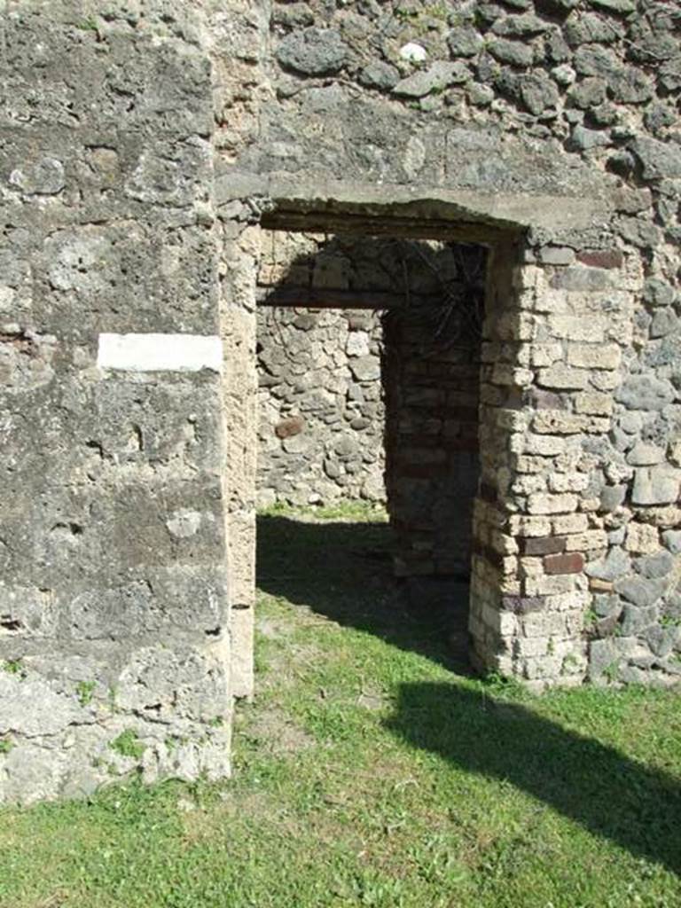 VII.4.57. Pompeii.  March 2009.  Doorway to Room 16. Kitchen, Latrine and stairs to upper floor.