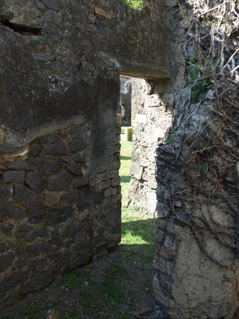 VII.4.57. Pompeii.  March 2009.  Room 16.  Door in north wall, leading to corridor and doorway into East Portico.