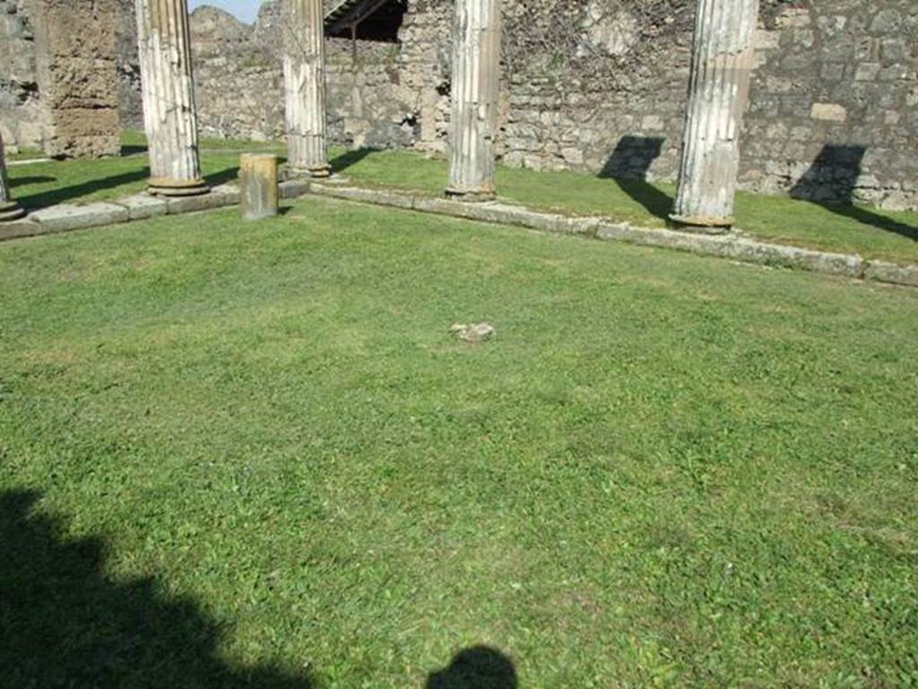 VII.4.57. Pompeii.  March 2009.  Peristyle.  Looking north east towards sundial. The remains of one small masonry column are all that is left of  six that used to support a pergola in the centre of the Peristyle.