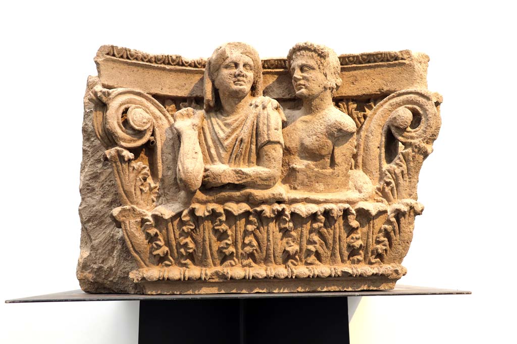 VII.4.57 Pompeii. February 2021.
Figures of a man and woman on house entrance capital. This would have faced into the vestibule on the top of right-hand side of entrance.
Photographed in Antiquarium. Photo courtesy of Fabien Bièvre-Perrin (CC BY-NC-SA).