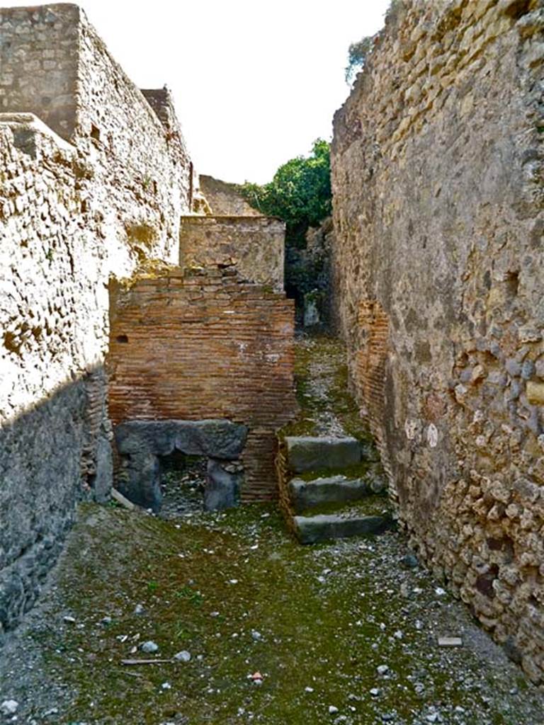 VII.5.7 Pompeii. May 2011. Looking south from entrance (26) across the furnace room (25). Remains of praefurnium front (27) between the men’s and women’s baths. Photo courtesy of Michael Binns.