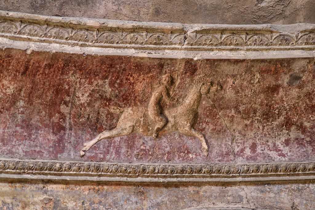 VII.5.24 Pompeii. April 2018. Detail of cupid on horse-back from stucco cornice on south side.
Photo courtesy of Ian Lycett-King. Use is subject to Creative Commons Attribution-NonCommercial License v.4 International.
