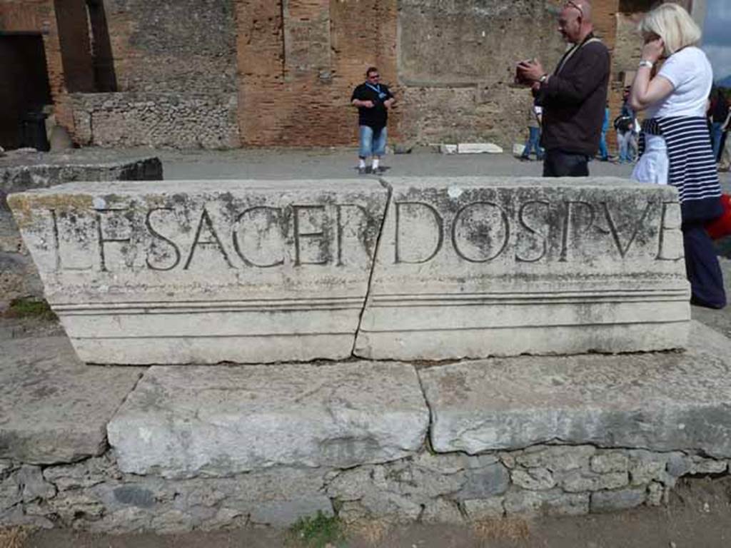 VII.8 Pompeii Forum. May 2010. Part of the Latin inscription in large letters on the entablature of the portico, reading -
L. F. SACERDOS PUB
The full inscription was similar to the one above the entrance at VII.9.67:
EUMACHIA L. F., SACERD(OS) PUBL(ICA), NOMINE SUO ET
M. NUMISTRI FRONTONIS FILI CHALCIDICUM, CRYPTAM, PORTICUS CONCORDIAE
AUGUSTAE PIETATI SUA PEQUNIA FECIT EADEMQUE DEDICAVIT.
See Mau, A., 1907, translated by Kelsey F. W. Pompeii: Its Life and Art. New York: Macmillan. (p.111)
Eumachia, daughter of Lucius, public priestess, in her own name and that of her son, Marcus Numistrius Fronto, built at her own expense the chalcidicum, crypt and portico in honour of Augustan Concord and Piety and also dedicated them.
See Cooley, A. and M.G.L., 2004. Pompeii : A Sourcebook. London : Routledge. (p.100, E42)