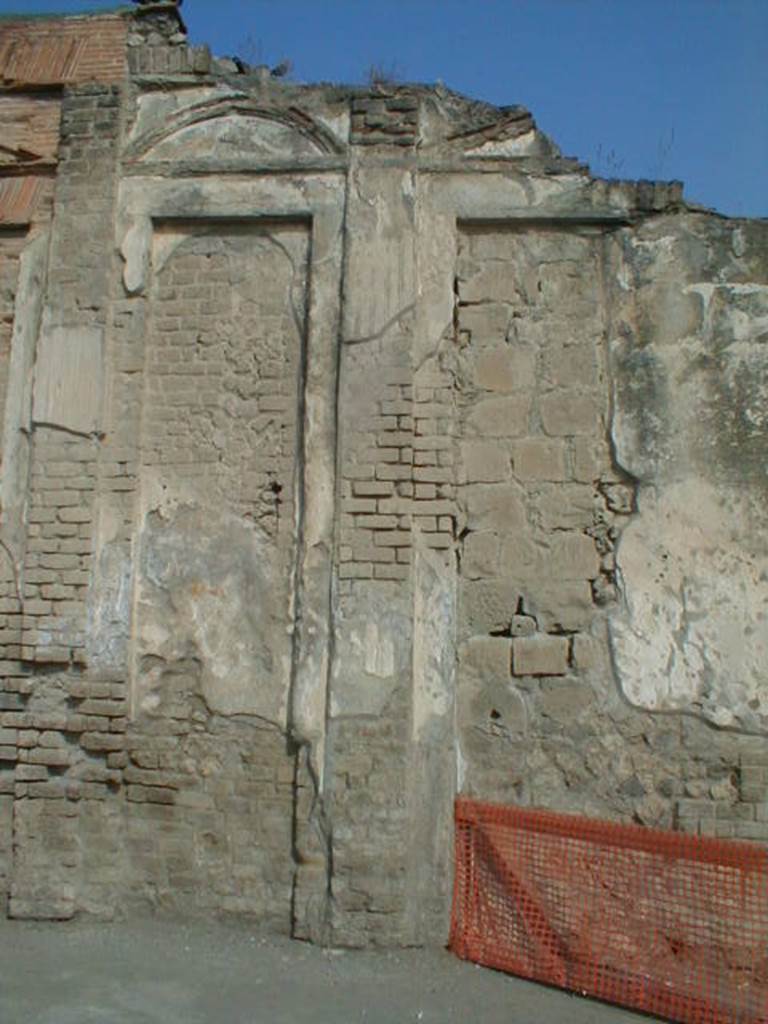 VII.9.1 Pompeii. September 2004. Eumachia’s Building. Plaster details on outside wall of building on Via Dell’ Abbondanza.