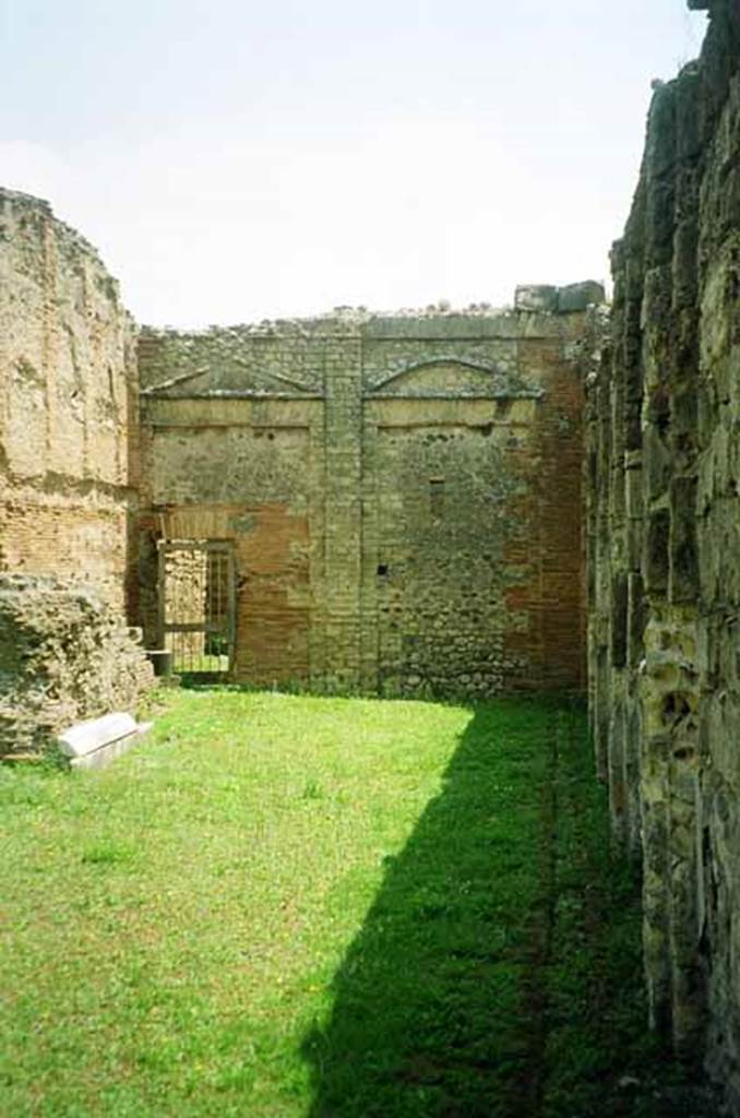 VII.9.2 Pompeii. July 2010. East wall between cella and south wall. The door at the back leads to three interconnected rooms which may have been accommodation or for storage. The northern most of these rooms connects with rooms at the rear of VII.9.3, the Sanctuary of the Public Lares. The purpose of this connection is unknown. Photo courtesy of Rick Bauer.