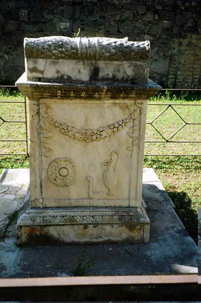 VII.9.2 Pompeii. July 2010. Altar. North side. According to Mau, the north and south sides have representations of ceremonial objects used in sacrificing. On this side is the libation bowl (patera), a ladle (simpulum) and a pitcher. See Mau, A., 1907, translated by Kelsey F. W. Pompeii: Its Life and Art. New York: Macmillan. (Page 107). Photo courtesy of Rick Bauer.