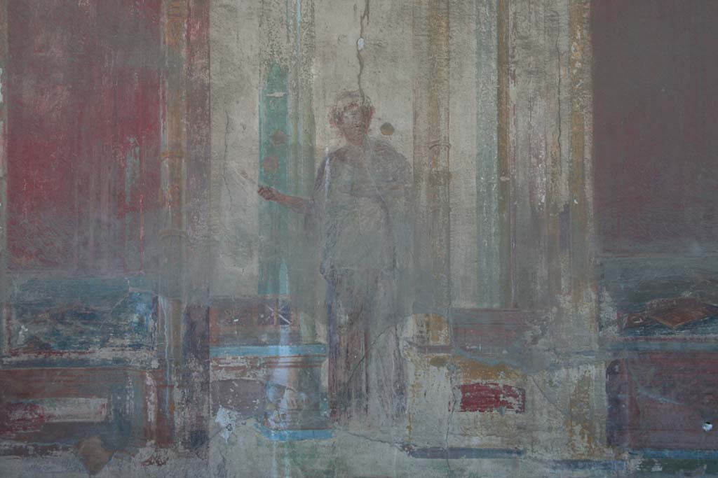 VII.9.7 and VII.9.8 Pompeii. Macellum. April 2013.  
North-west corner. Detail of architectural painting with female figure, from west wall.
