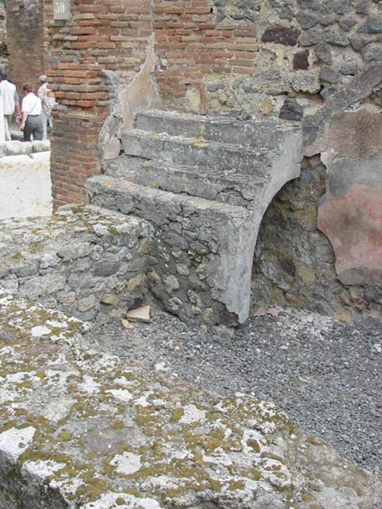 VII.9.30 Pompeii. May 2003. Shelving for display of crockery, with recess below, at east end of counter. Photo courtesy of Nicolas Monteix.