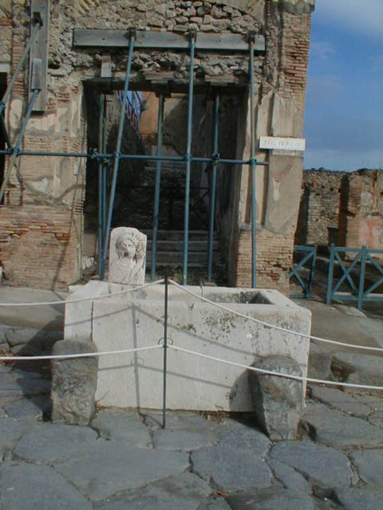 VII.9.67 Pompeii. September 2004. Rear stairs in Eumachia’s building and fountain on Via dell’ Abbondanza. Looking north.
