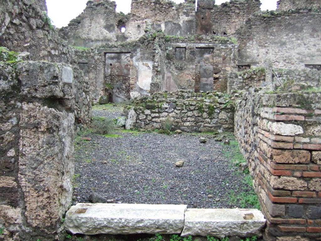VII.10.12 Pompeii. December 2005. Looking west across shop towards doorway to atrium of dwelling.