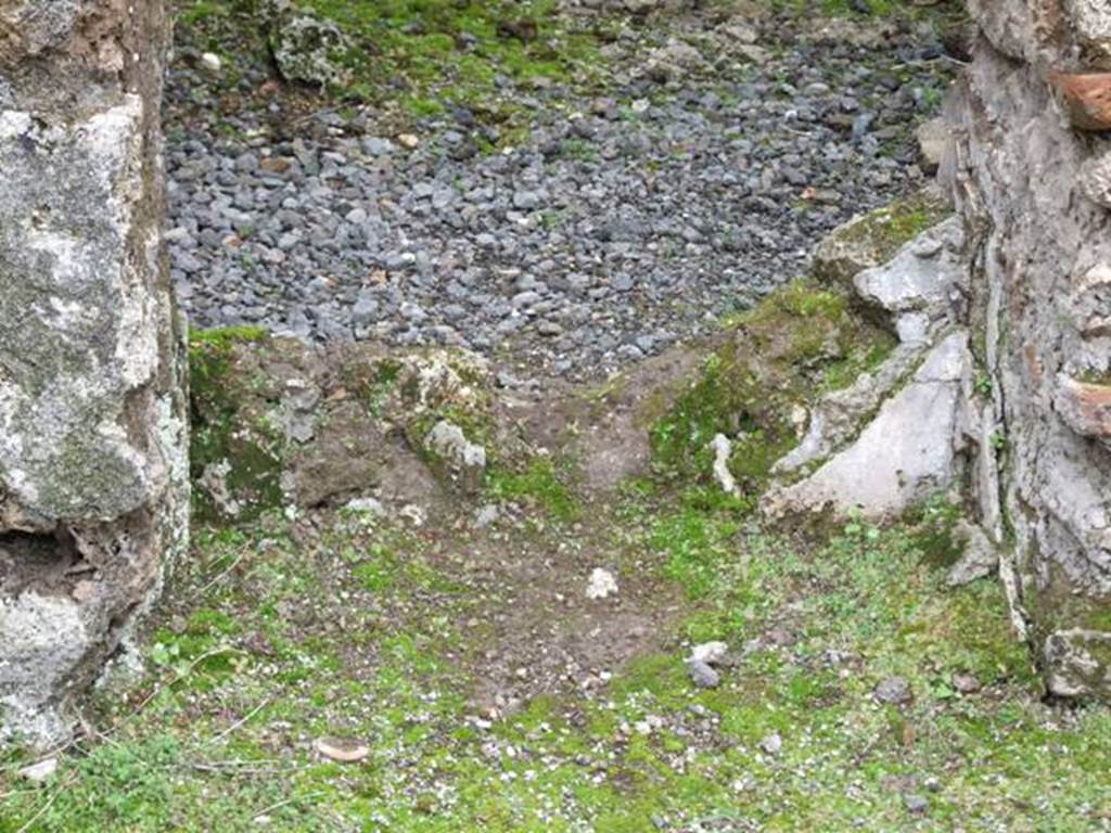VII.10.12 Pompeii.  March 2009. Looking west at wall with a door with plaster in the lower area.