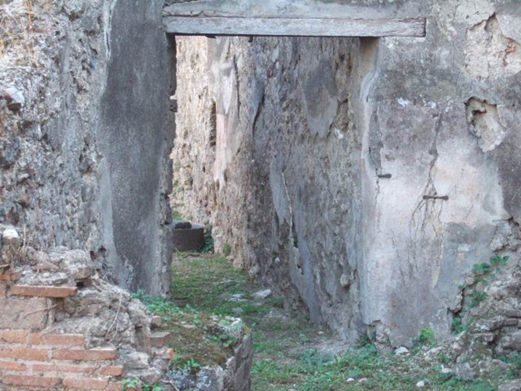 VII.12.14 Pompeii. September 2005. Corridor to rear. According to Jashemski, there was probably a garden in the open area at the rear of this shop-house which Della Corte had identified as a location of a school.
She gave references – Fiorelli, Scavi, pp. 19: Idem: Descr. p. 284.
Della Corte, « Scuole e maestri in Pompei antica » Studi Romani, 7 (1959). 
See Della Corte, M., 1965.  Case ed Abitanti di Pompei. Napoli: Fausto Fiorentino. (p.183-4).
See Jashemski, W. F., 1993. The Gardens of Pompeii, Volume II: Appendices. New York: Caratzas. (p.193)
