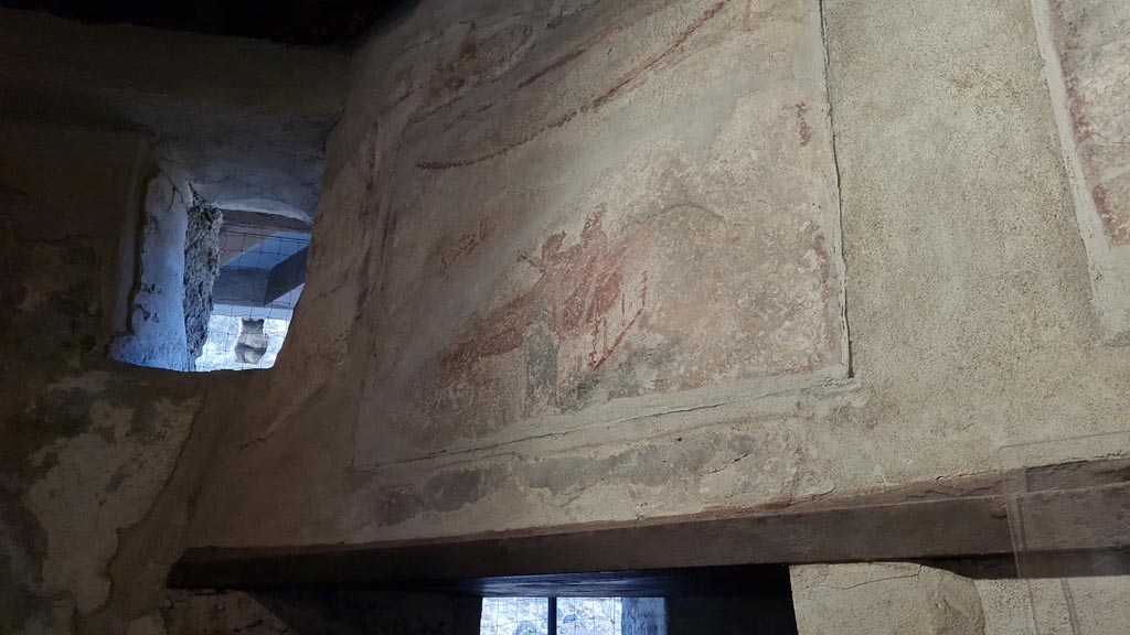 VI.12.18 Pompeii. April 2022. 
Erotic wall paintings on frieze on west wall above doorway to latrine. Photo courtesy of Giuseppe Ciaramella.
